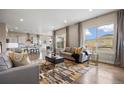 Spacious living room boasts hardwood floors, neutral decor, and views from large windows at 10659 Montecito Dr, Lone Tree, CO 80124