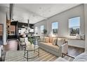 Spacious open-concept living room featuring hardwood floors, large windows, and modern decor at 2501 15Th St # 3F, Denver, CO 80211
