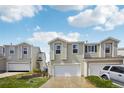 Two-story home with white siding, attached garages, and manicured lawn at 21961 E Crestline Pl, Aurora, CO 80015
