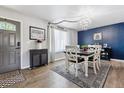 Cozy dining room with hardwood floors, a modern chandelier, elegant rug, and stylish decor at 3253 S Kalispell St, Aurora, CO 80013
