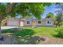 Well-maintained ranch home with brick and vinyl siding, solar panels, attached garage, and a manicured lawn at 3253 S Kalispell St, Aurora, CO 80013