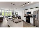Modern kitchen with granite countertops, stainless steel appliances, and an island at 7240 W Custer Ave # 205, Lakewood, CO 80226
