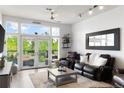 Spacious living room with large windows, hardwood floors, and comfy furniture at 7240 W Custer Ave # 205, Lakewood, CO 80226