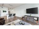 Open living area with hardwood floors and a modern media console at 7240 W Custer Ave # 205, Lakewood, CO 80226