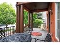 Inviting covered front porch featuring comfortable seating, decorative columns, and ample space for relaxing at 8728 E 25Th Dr, Denver, CO 80238