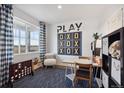 Inviting playroom featuring a tic-tac-toe game, cozy seating, and natural light, perfect for activities at 43124 Kawana Gulch St, Elizabeth, CO 80107