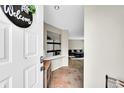 Welcoming entryway featuring tile flooring and views of the living room in this charming home at 1226 S Monaco Pkwy # 308, Denver, CO 80224