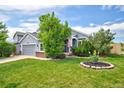 Inviting two-story home with lush green lawn and charming landscaping at 2295 Sandhurst Dr, Castle Rock, CO 80104