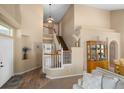 Open-concept foyer showcasing a staircase, hardwood floors, and elegant decor at 2295 Sandhurst Dr, Castle Rock, CO 80104