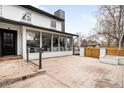 A stone patio behind a house with a sliding glass door at 4362 Peach Ct, Boulder, CO 80301