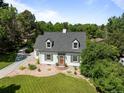Charming two-story home with a well-manicured lawn, red front door, and beautiful landscaping at 1033 Estes St, Lakewood, CO 80215