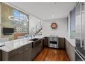 Modern kitchen with stainless steel appliances, hardwood floors, and beautiful countertops at 1050 Cherokee St # 403, Denver, CO 80204