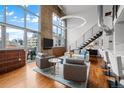 Bright living room featuring floor-to-ceiling windows and hardwood floors at 1050 Cherokee St # 403, Denver, CO 80204