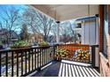 Relaxing front porch with a porch swing, perfect for enjoying the outdoors at 1127 Clayton St, Denver, CO 80206