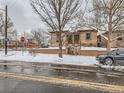 Street view of a brick home with a snowy yard at 3256 N Clay St, Denver, CO 80211