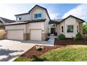 Two-story home featuring a two-car garage, manicured lawn, and inviting front entrance at 9983 Cottoncreek Dr, Highlands Ranch, CO 80130