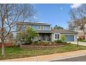 Charming two-story home featuring a well-manicured front yard and an attached garage at 6062 S Emporia Cir, Englewood, CO 80111