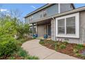 Inviting walkway leading to the front door of this charming home with beautiful landscaping at 6062 S Emporia Cir, Englewood, CO 80111