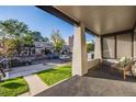 Spacious front porch offers a welcoming view of the street with well-maintained lawns and mature trees at 544 N Logan St, Denver, CO 80203