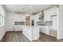 Bright kitchen featuring white cabinets, stainless steel appliances, and an island at 1876 Chaffee Crest Dr, Berthoud, CO 80513