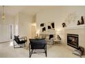 Bright living room boasts high ceilings, neutral walls, a fireplace, and stylish, modern furnishings at 160 Las Lunas St, Castle Rock, CO 80104