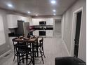 Bright kitchen featuring stainless steel appliances, white cabinetry and modern table set at 4673 Sherman St, Denver, CO 80216