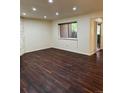 A living room with wood floors and a view of the outside through a window at 9427 W 89Th Cir, Broomfield, CO 80021