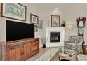 Cozy living room features a fireplace, large television, comfortable seating and attractive decor at 1982 Peralta Loop, Castle Rock, CO 80104