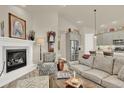 Open-concept living room connects to the kitchen and boasts fireplace and comfortable seating at 1982 Peralta Loop, Castle Rock, CO 80104