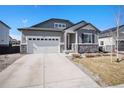 Charming single Gathering home with a well-manicured lawn, two car garage and stone accents at 22591 E Narrowleaf Cir, Aurora, CO 80016