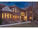 Attractive brick home with a unique turret design, complemented by a well-maintained lawn and inviting walkway at 5 Tamarade Dr, Littleton, CO 80127