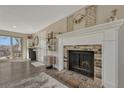 Living room showcasing a brick fireplace, sliding glass doors leading to the backyard, and hardwood floors at 280 Jupiter Dr, Lone Tree, CO 80124