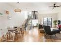 Bright, open-concept living room with modern staircase, hardwood floors, and ample natural light at 2589 Arapahoe St, Denver, CO 80205