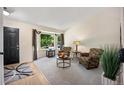 Bright living room with large window, neutral carpet, and stylish furnishings, perfect for relaxation at 5750 S Youngfield St, Littleton, CO 80127