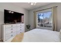 Comfortable bedroom with a dresser, television, and large window with natural light at 1671 W Canal Cir # 221, Littleton, CO 80120