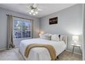 Inviting bedroom featuring a comfortable bed, ceiling fan, and large window with natural light at 1671 W Canal Cir # 221, Littleton, CO 80120
