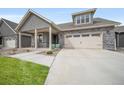Exterior view of a home with a spacious concrete driveway leading up to a charming two-car garage at 331 Josef Cir, Fort Lupton, CO 80621
