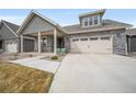 Charming home with a two-car garage, covered porch, and inviting curb appeal at 331 Josef Cir, Fort Lupton, CO 80621