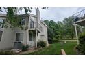 Exterior view of condo shows private balcony, lawn and mature trees at 13854 E Lehigh Ave # D, Aurora, CO 80014