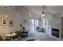 Living room with cathedral ceilings, fireplace and slider to balcony at 13854 E Lehigh Ave # D, Aurora, CO 80014