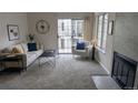 Bright living room with fireplace and large windows at 13854 E Lehigh Ave # D, Aurora, CO 80014
