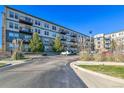 Exterior shot of the condo building showcases its modern architecture and well-maintained landscaping at 13598 Via Varra # 301, Broomfield, CO 80020