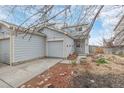 Charming home features a one-car garage, well-maintained front yard with shrubs, and a welcoming entrance at 649 Mockingbird St, Brighton, CO 80601