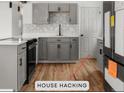Remodeled kitchen showcasing new appliances, updated cabinets, sleek countertops, and hardwood flooring at 4701 E Jewell Ave, Denver, CO 80222