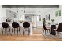Bright kitchen has updated appliances, lots of cabinets, and a breakfast bar with modern counter stools at 4701 E Jewell Ave, Denver, CO 80222