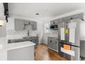 Remodeled kitchen featuring new appliances, gray cabinets, sleek countertops, and new hardwood flooring at 4701 E Jewell Ave, Denver, CO 80222