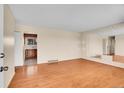 Open living room features hardwood floors, natural light, and an inviting space for relaxation and entertainment at 5510 Troy St, Denver, CO 80239