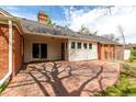 Enjoy outdoor living on this spacious brick patio with access to the home through sliding glass doors at 3756 S Forest Way, Denver, CO 80237