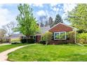 Lovely brick home with lush green lawn, mature trees, and a paved walkway leading to the entrance at 3756 S Forest Way, Denver, CO 80237