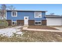 Charming blue house with brick accents and a spacious yard at 15934 E Columbia Pl, Aurora, CO 80013